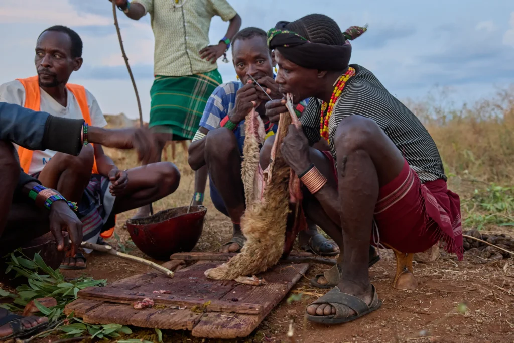 Hamar men preparing goat meat during traditional ceremony in southern Ethiopia | Michaela Pupíková Photography