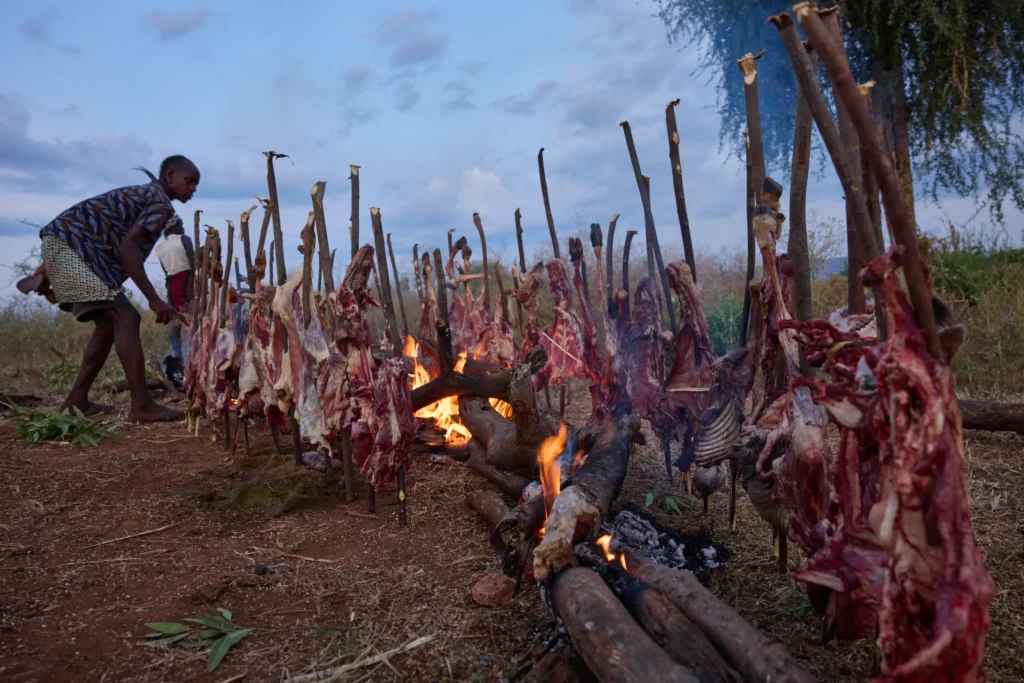 Fresh meat roasting over open fire during Hamar tribe bull jumping feast in Ethiopia | Michaela Pupíková Photography