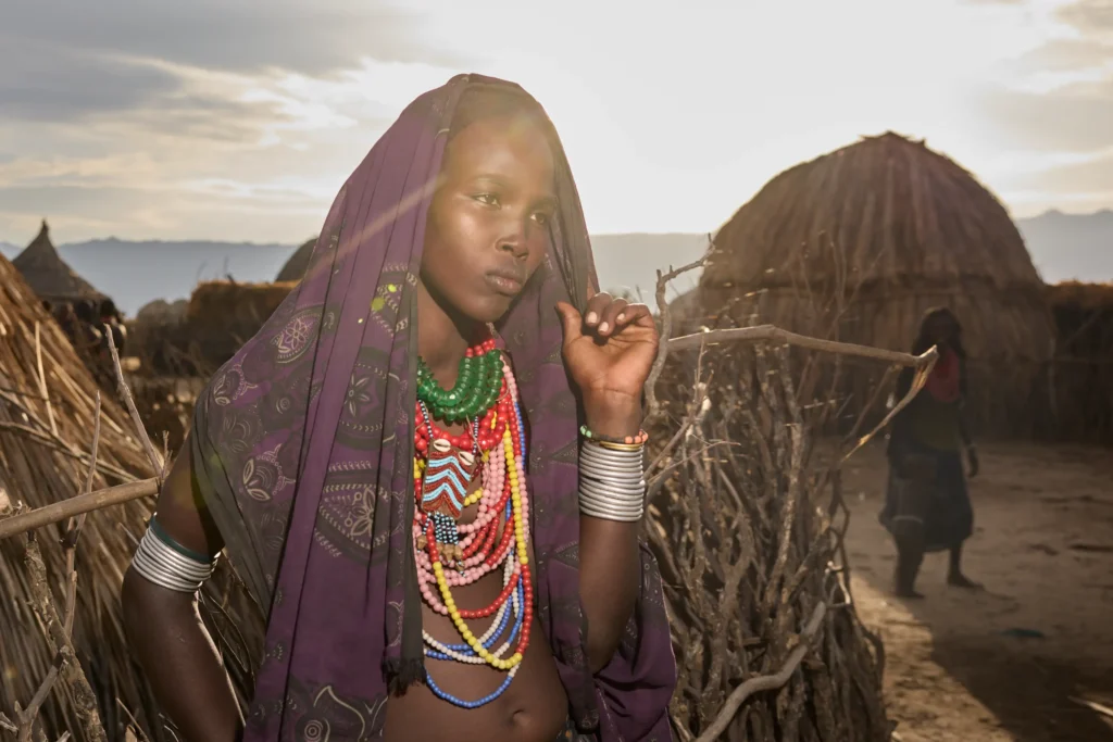 Portrait of Arbore woman with layered bead necklaces and headscarf in Ethiopian village | Michaela Pupíková Photography