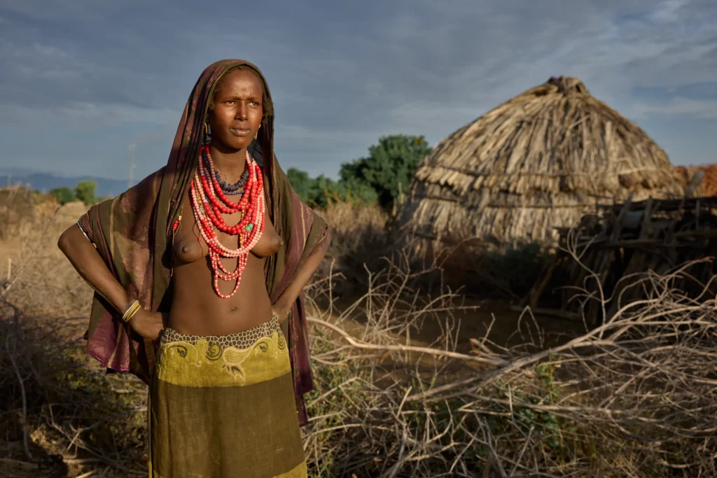 Arbore woman standing proudly among thatched huts in southern Ethiopia | Michaela Pupíková Photography