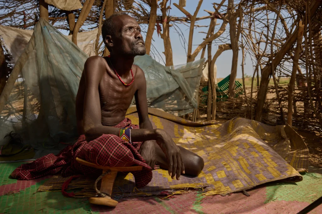 Dassanech elder seated under handmade shelter in tribal village, Ethiopia | Michaela Pupíková Photography