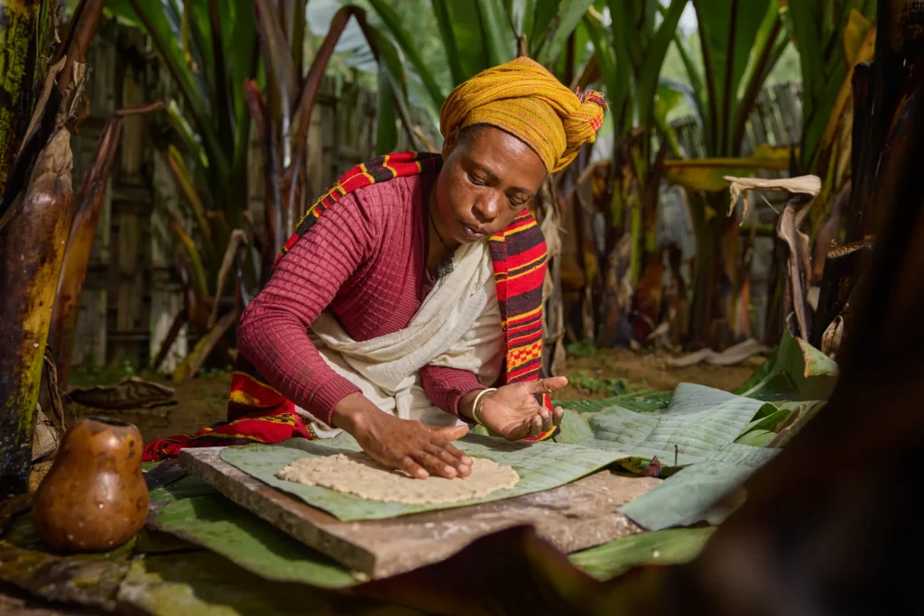Traditional Dorze bread-making from fermented enset, kneading dough by hand. Dorze village kitchen, Ethiopia | Michaela Pupíková Photography
