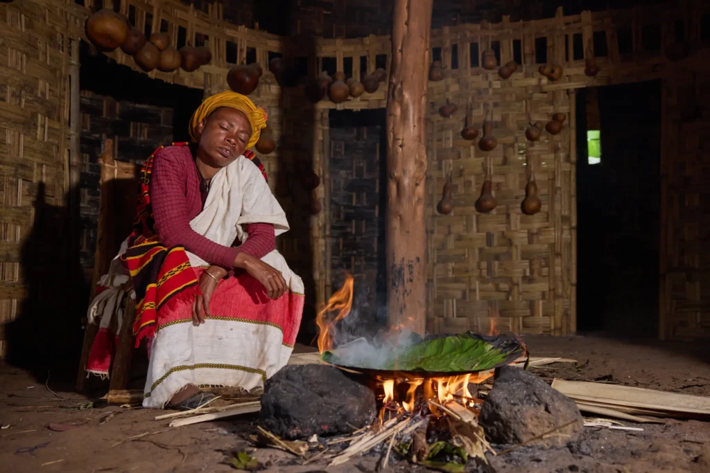 Baking enset bread over open fire in a Dorze village kitchen, Ethiopia | Michaela Pupíková Photography